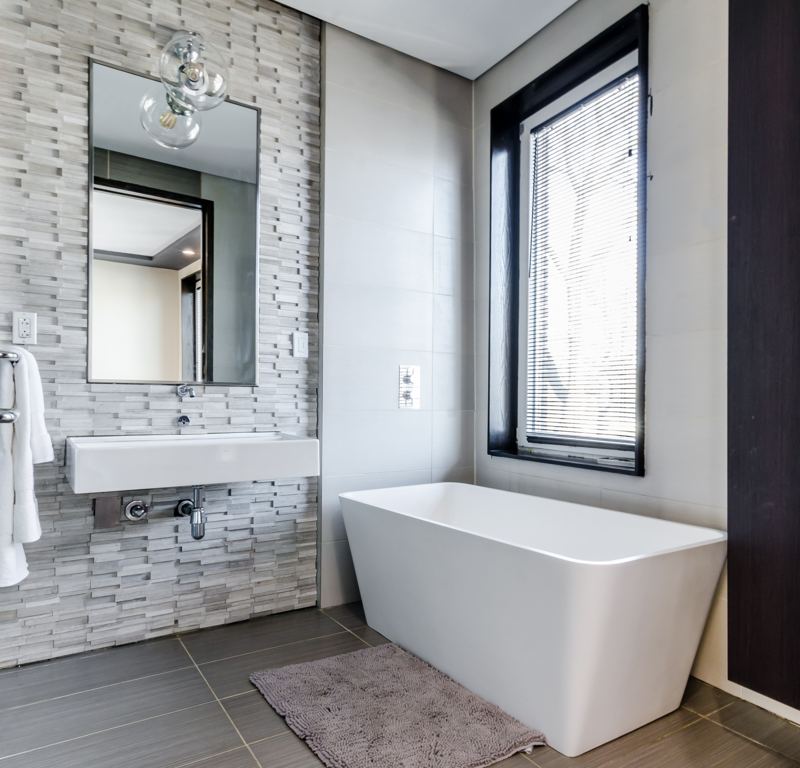 A bright, calm bathroom with a freestanding bath